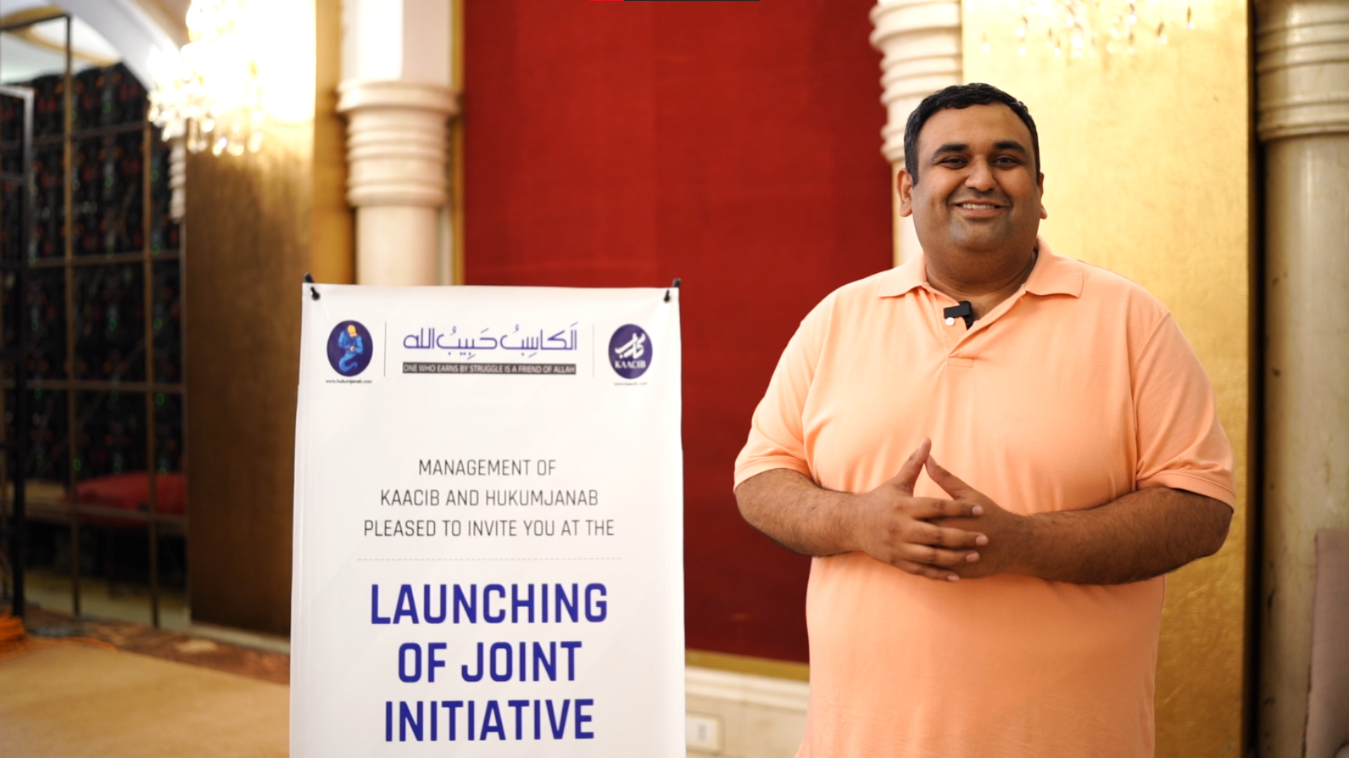Syed Azfar Hussain standing next to a banner announcing the KAACIB and HukumJanab joint initiative launch event.